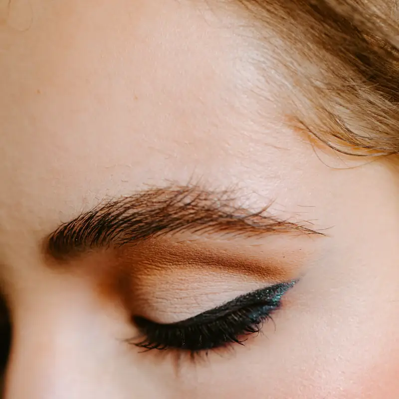 Close-up of a groomed brow and a sharp black liner wing