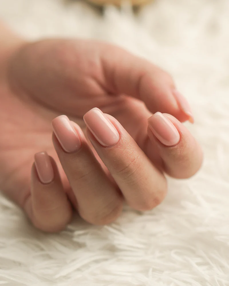 Nude rounded nails on soft white faux fur