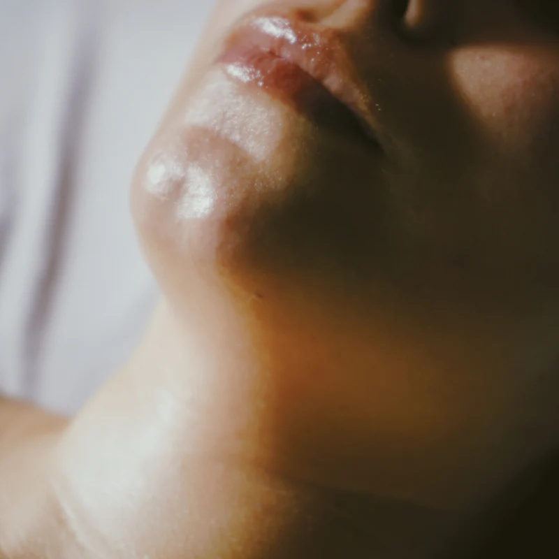 Glowing skin on a jawline in warm side light