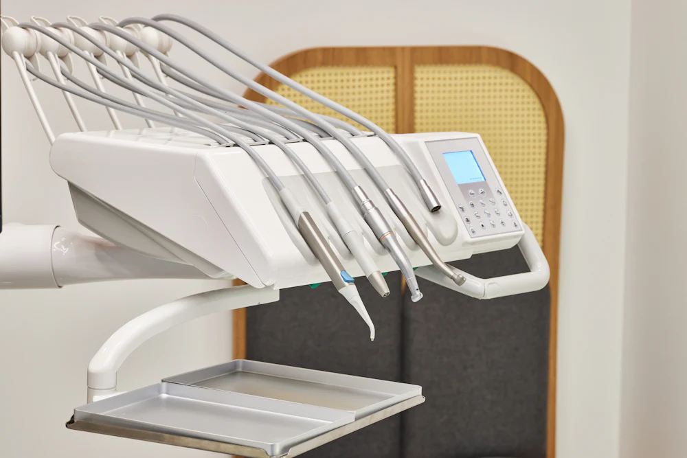 Dental instrument tray in front of a warm rattan arch panel