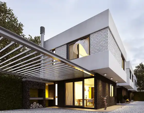 Modern two-storey home with a steel pergola and warm interior lights at dusk