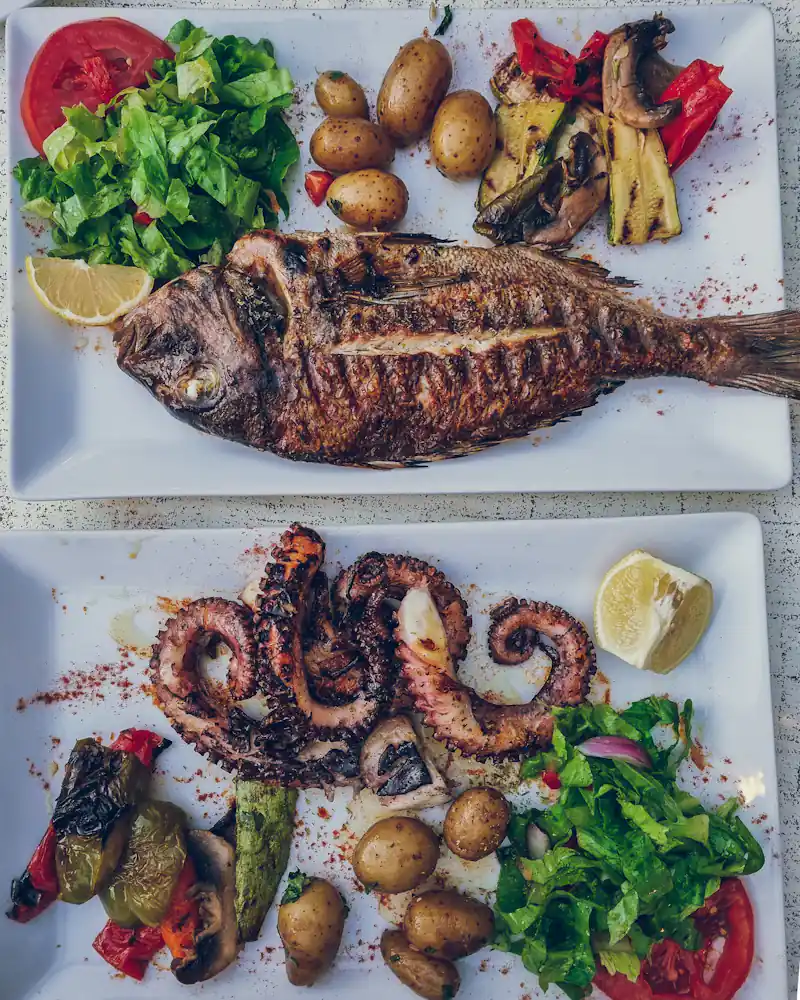 Whole grilled fish and grilled octopus with potatoes and salad